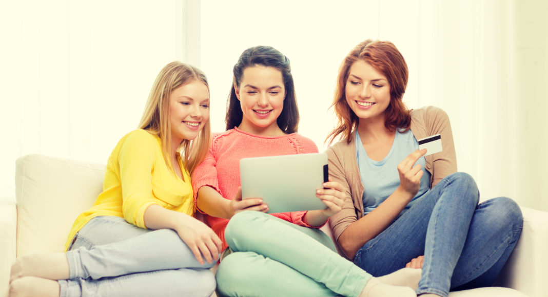 teenage girls with tablet pc and credit card